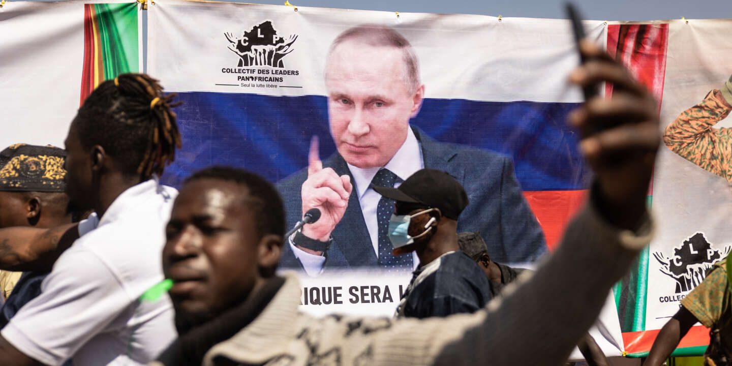 A banner of Russian President Vladimir Putin is seen during a protest to support the Burkina Faso President Captain Ibrahim Traore and to demand the departure of France's ambassador and military forces, in Ouagadougou, on January 20, 2023. (Photo by OLYMPIA DE MAISMONT / AFP)